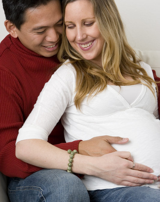 Pregnant Wife sitting with Husband