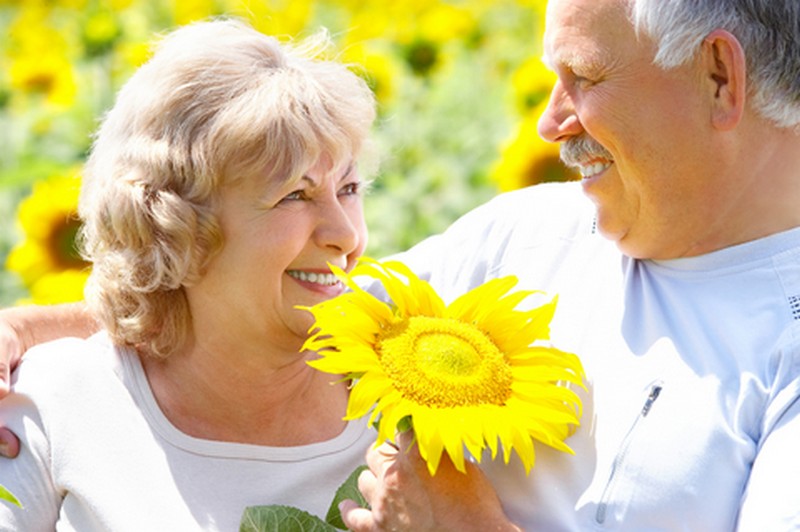 Senior Couple with large yellow flower