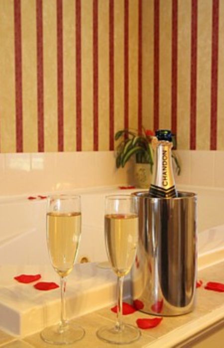 Champagne and Glasses by the Whirlpool Tub